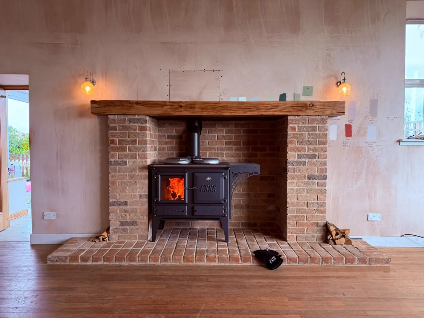 Finished Fife Stoves installation with brick chamber and oak beam mantel
