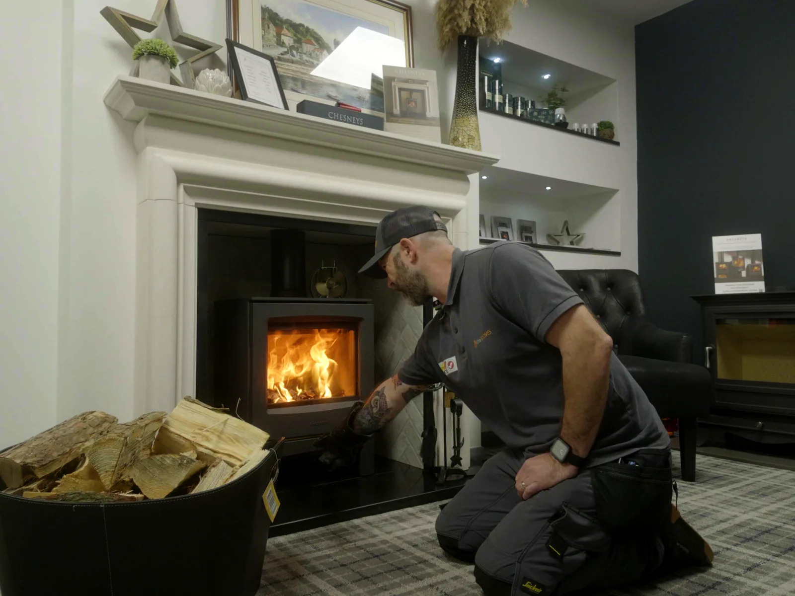 Chad Reekie tending a lit stove in the Fife Stoves showroom