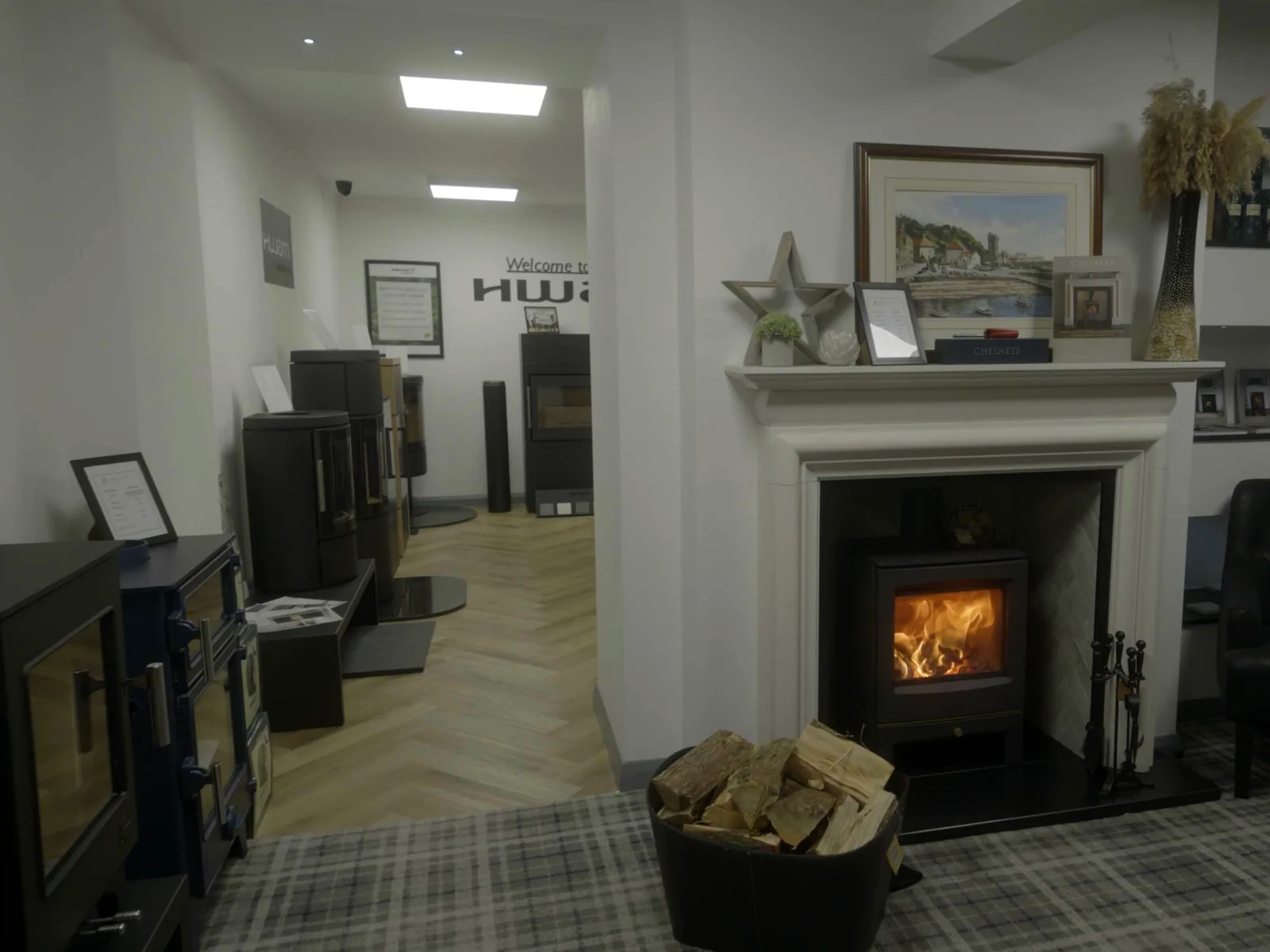 A lit stove beside a leather armchair in the Fife Stoves showroom, Kirkcaldy