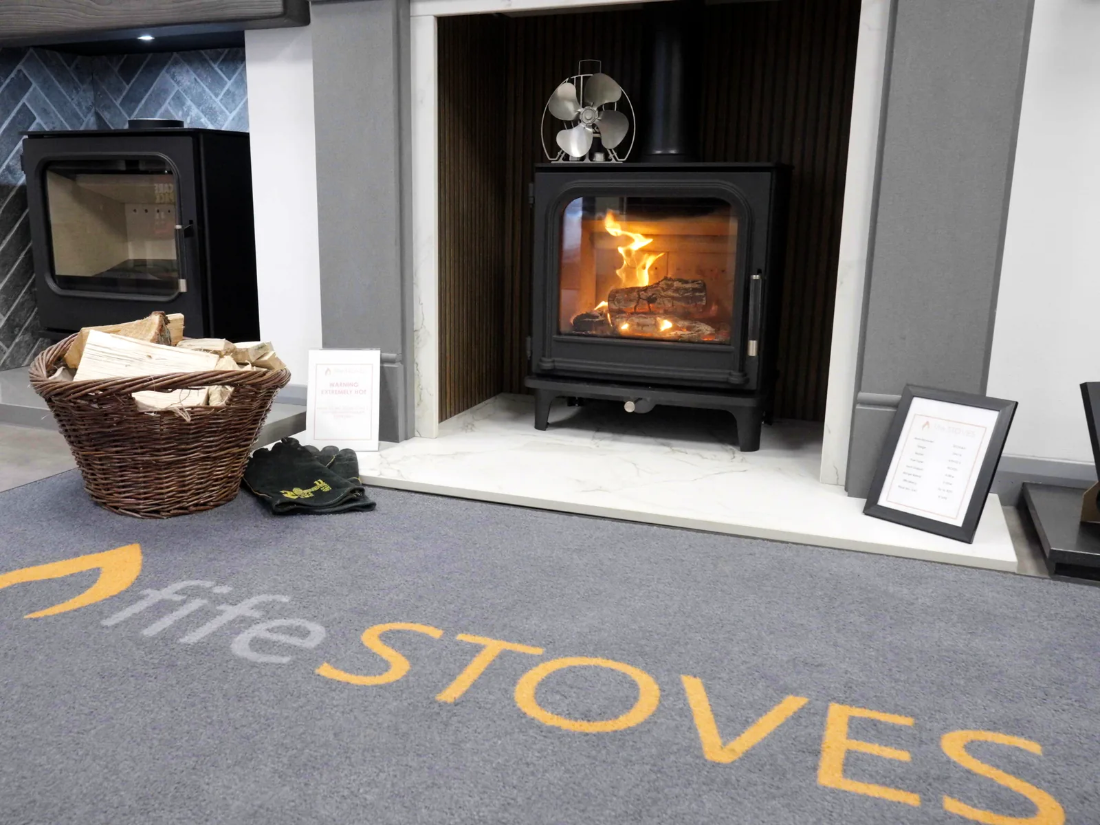 A lit stove on the Fife Stoves rug in the Kirkcaldy showroom